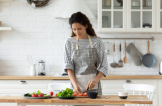 A woman prepares food to help her breastfeeding diet.