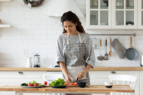 A woman prepares food to help her breastfeeding diet.