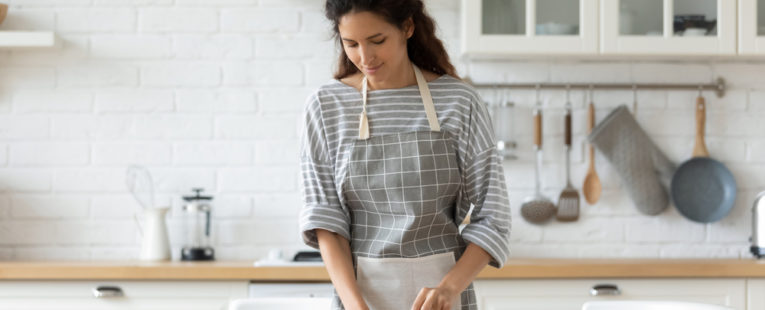 A woman prepares food to help her breastfeeding diet.
