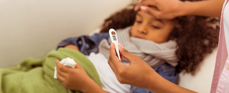 young girl has a fever related to the flu