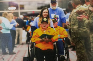 Hospice Nurse pushing Richmon Purl in a wheelchair
