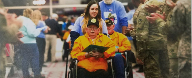 Hospice Nurse pushing Richmon Purl in a wheelchair