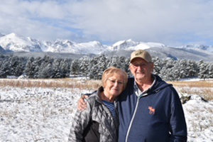 Ron and Melinda Cooling standing by mountains