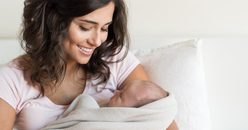 Mother and infant on a bed