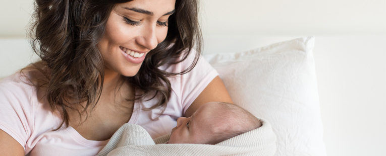 Mother and infant on a bed