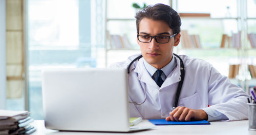 physician helping a patient remotely using a computer
