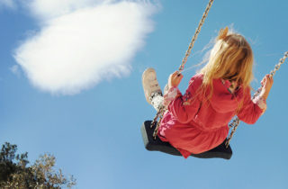Young girl on a swing