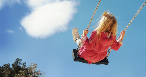 Young girl on a swing