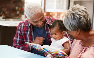 Grandparents reading to their grandchild