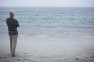 man contemplating at the beach