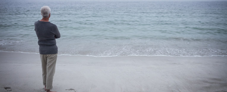man contemplating at the beach