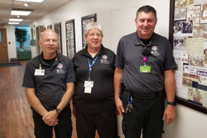 Howard Marsh, Joyce Willskey, and Todd Jones standing in their office at OSF PRO Ambulance.