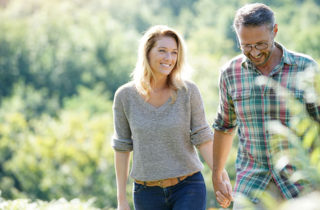 Man and Woman Walking in Field