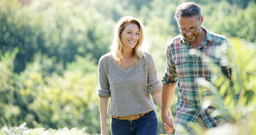 Man and Woman Walking in Field
