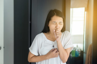 Asian-American woman with pneumonia coughing.