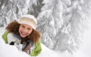 young girl playing in the winter snow