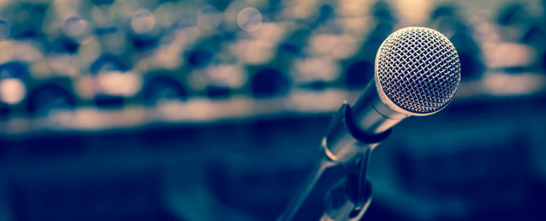 microphone at a podium in an empty hall