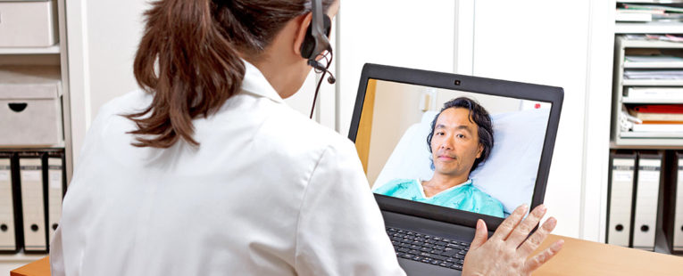 Tele-neurohospitalist meeting with a patient over the computer.