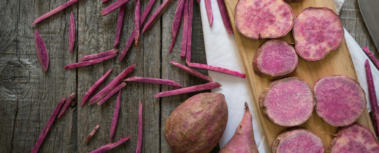 Purple potatoes on a cutting board