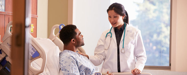 Physician consulting with patient in hospital shortly before surgery