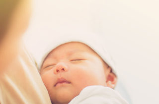 newborn baby and mother, wearing outfit from hospital bag