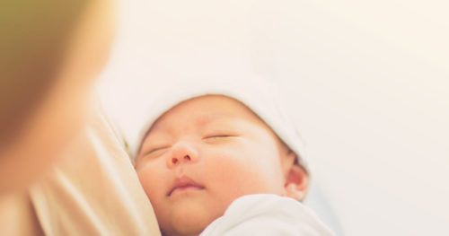 newborn baby and mother, wearing outfit from hospital bag