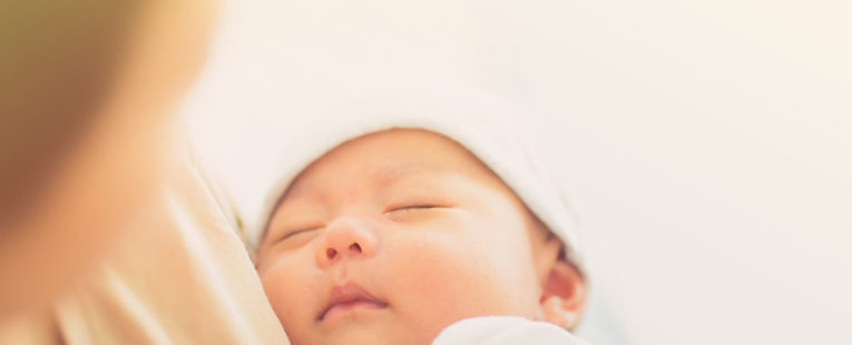 newborn baby and mother, wearing outfit from hospital bag