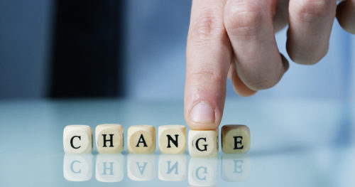 Hand on building blocks spelling change
