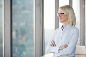 Office leader embracing change and looking out office window