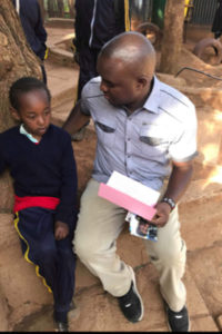 Michelle and Wismark reading a letter in Kenya