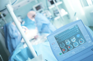 physicians treating a stroke patient in a hospital operating room