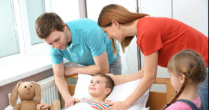 Happy family with their child after pediatric surgery.