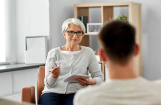 young man with anxiety speaking with therapist