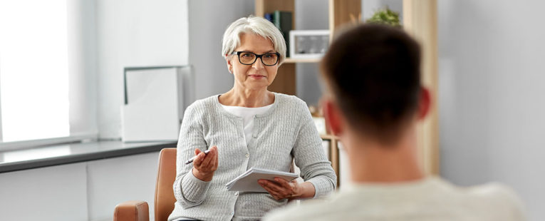 young man with anxiety speaking with therapist