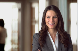 executive leader smiling in office lobby
