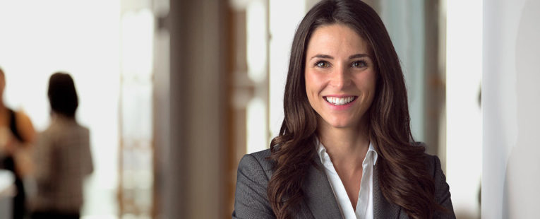 executive leader smiling in office lobby