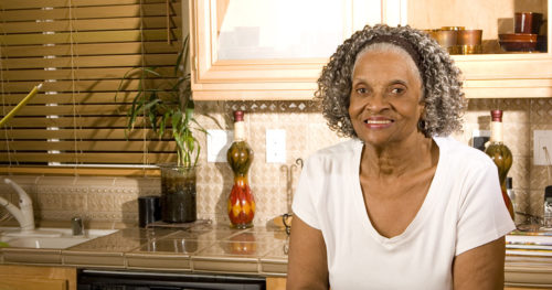 senior African-American woman alone in kitchen