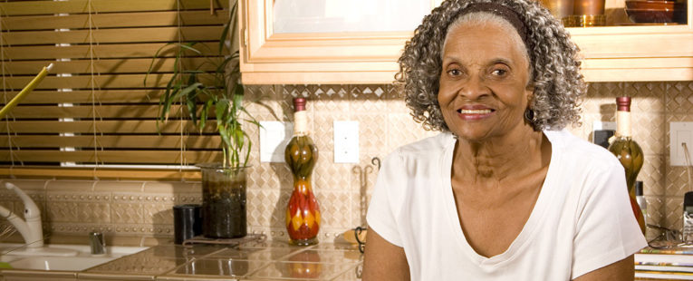 senior African-American woman alone in kitchen