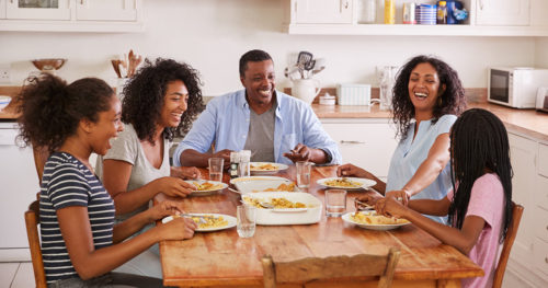 African-American family talking at the breakfast table practicing mindful eating