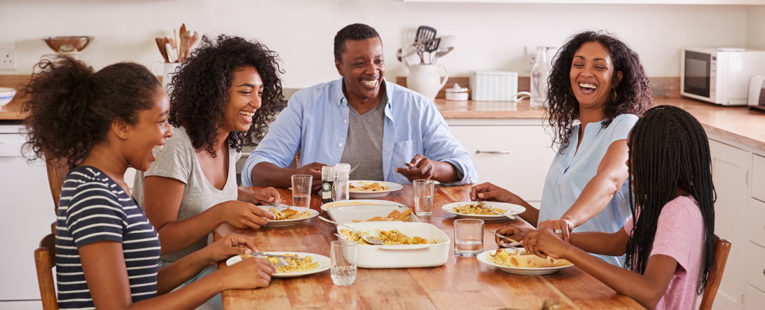 African-American family talking at the breakfast table practicing mindful eating
