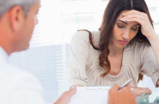 Doctor Giving Cancer Diagnosis to Woman