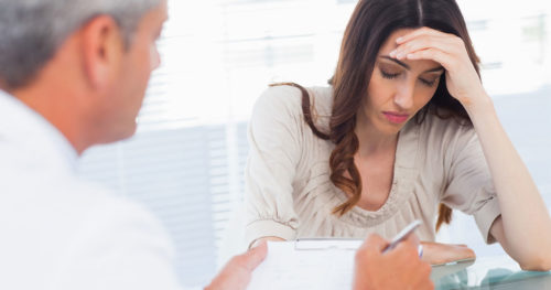 Doctor Giving Cancer Diagnosis to Woman