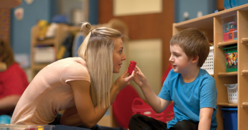 Therapist playing with young boy with autism