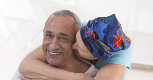 Female hospice patient hugging husband