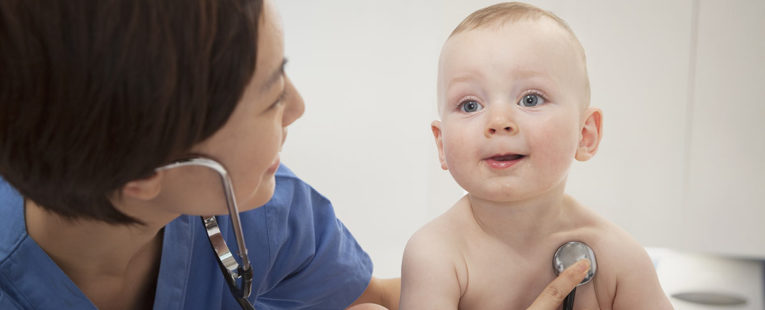 nurse taking infant boy's vital signs