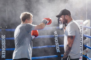 man training in boxing ring