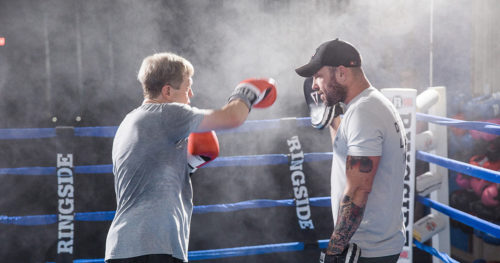 man training in boxing ring