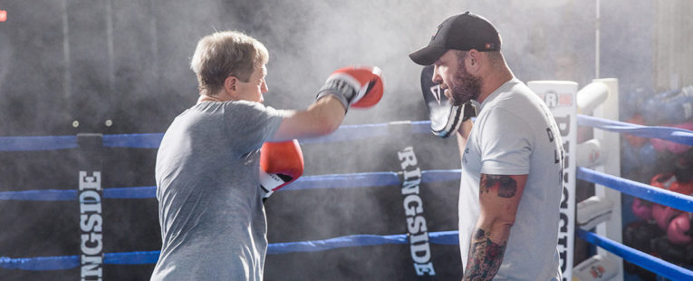 man training in boxing ring