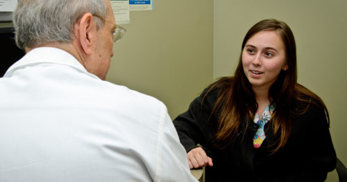 young female patient sharing family history with provider