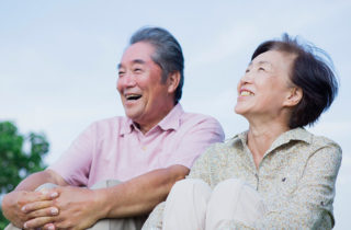 Senior couple outdoors discussing Medicare plans